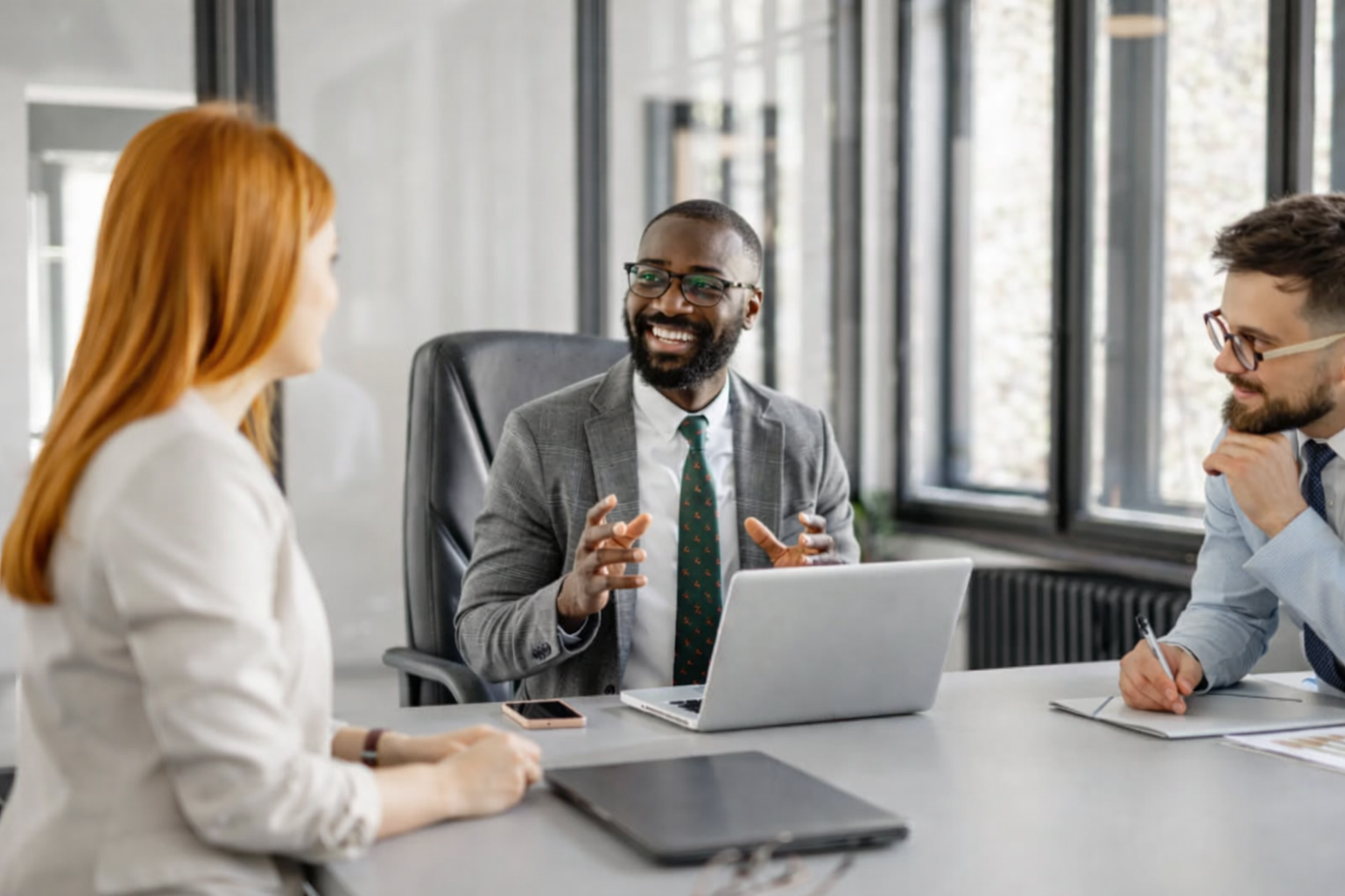 a group of professionals having a discussion at a conference table