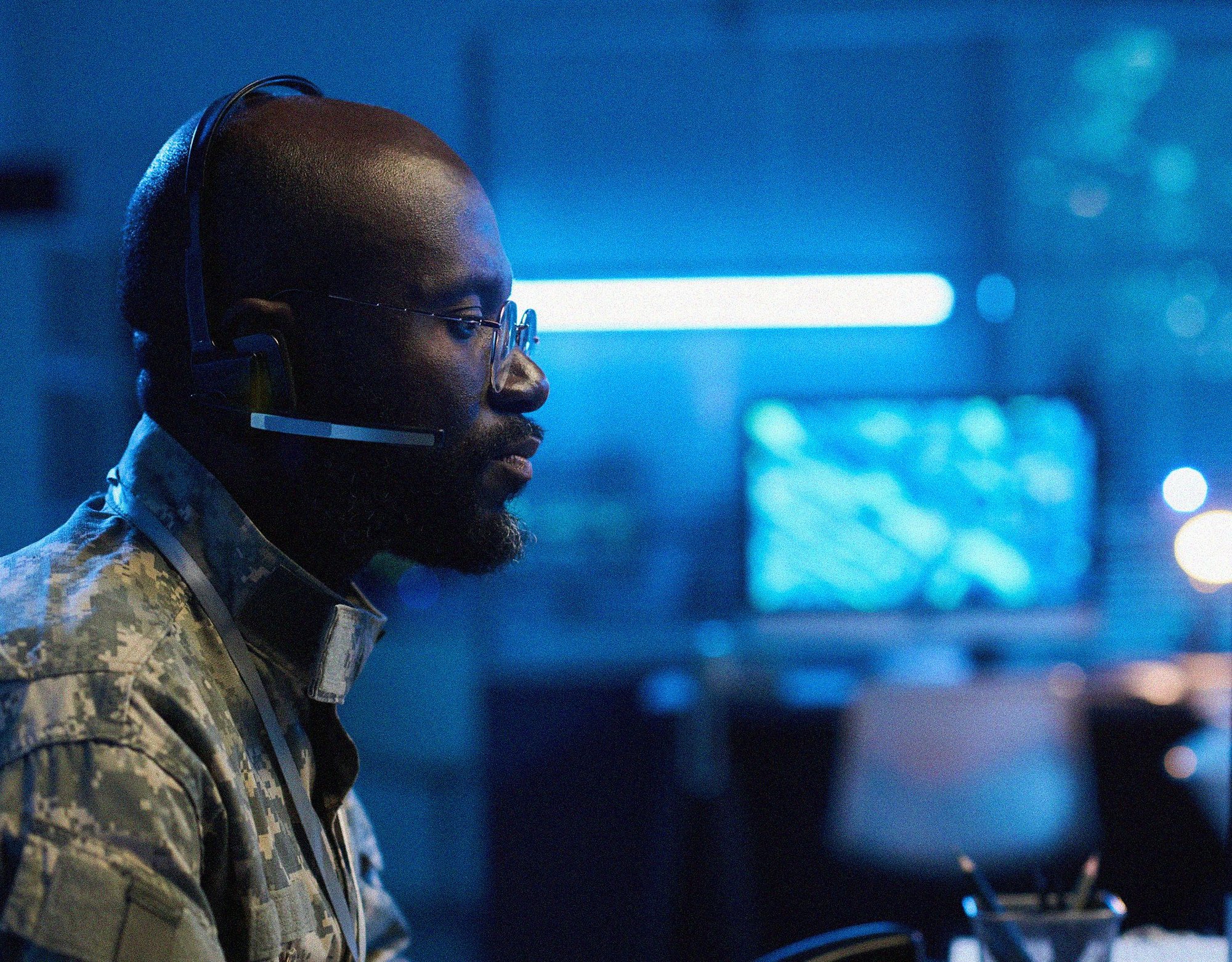 black military professional analyzing data on a computer