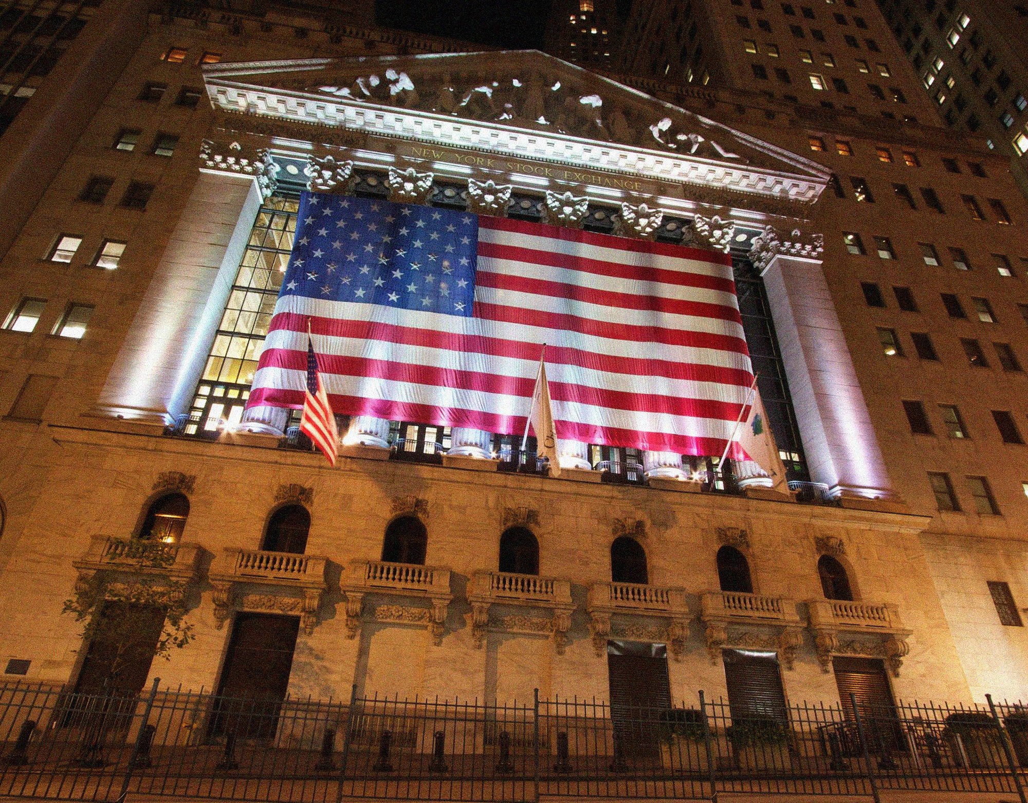 ground view of a federal building with a raised american flag
