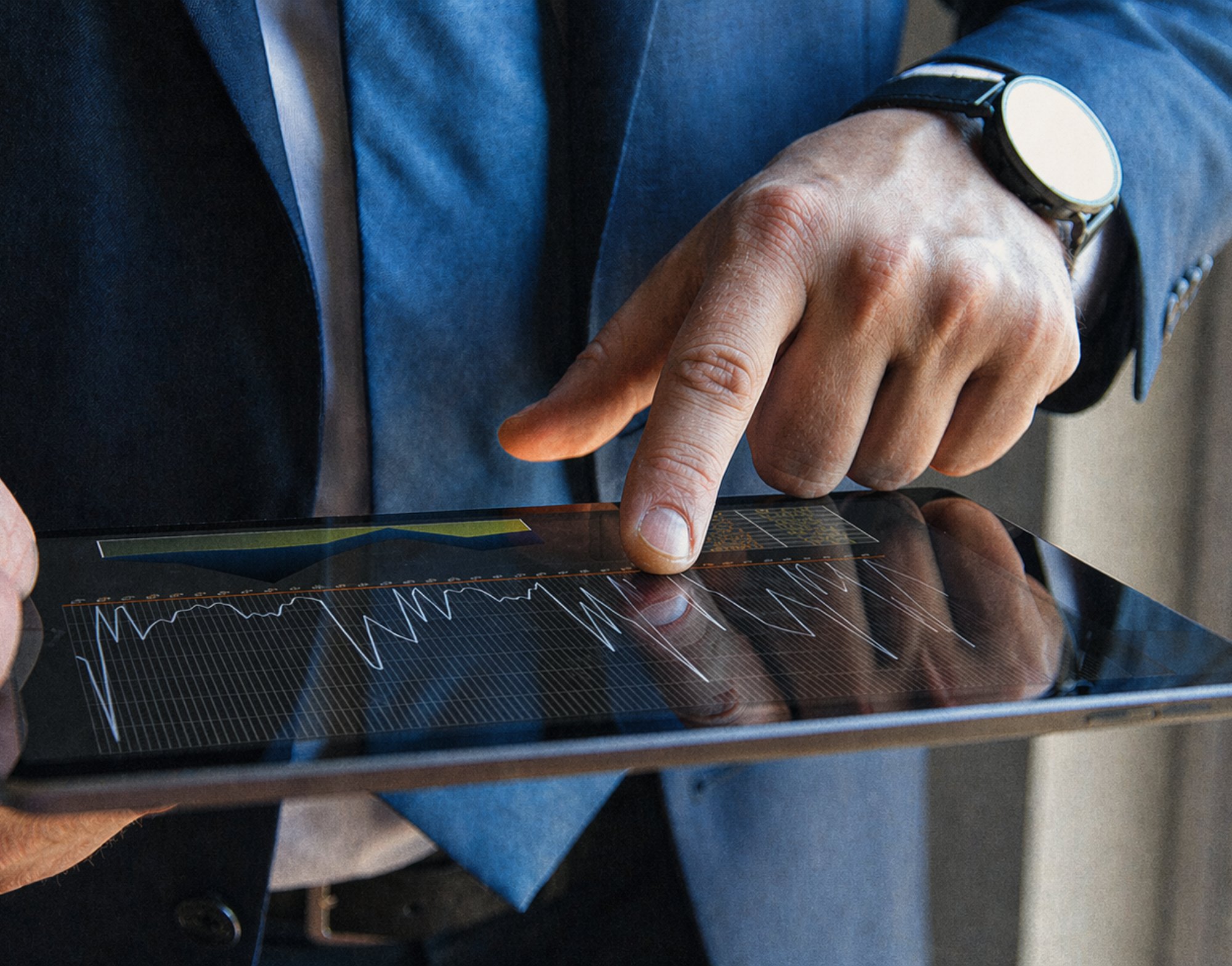 man analyzing stock on a tablet