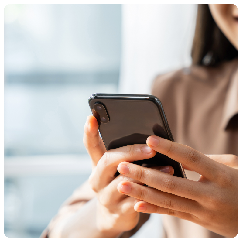 woman's hands typing on a smart phone