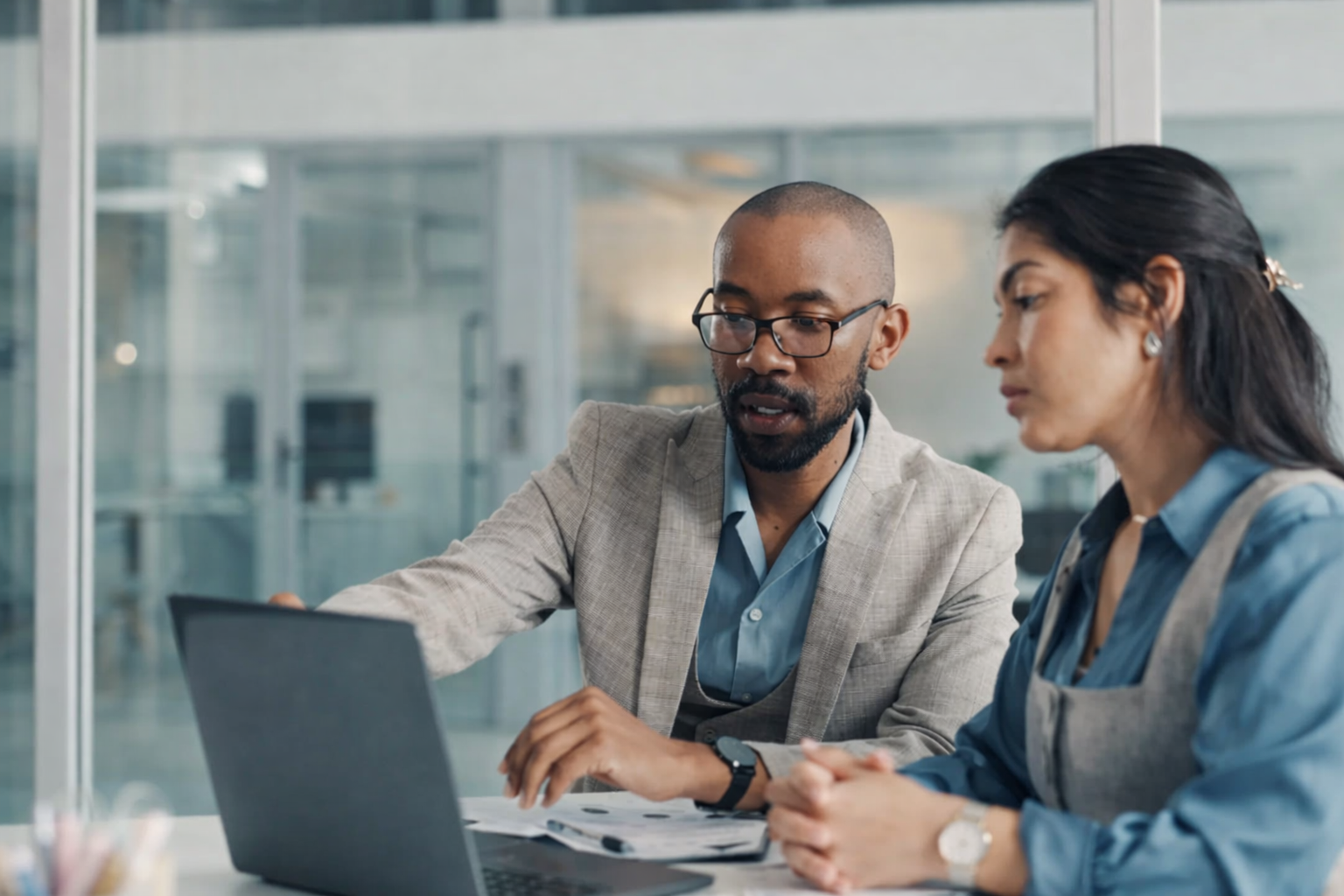 black male showing a mixed female data on a laptop monitor