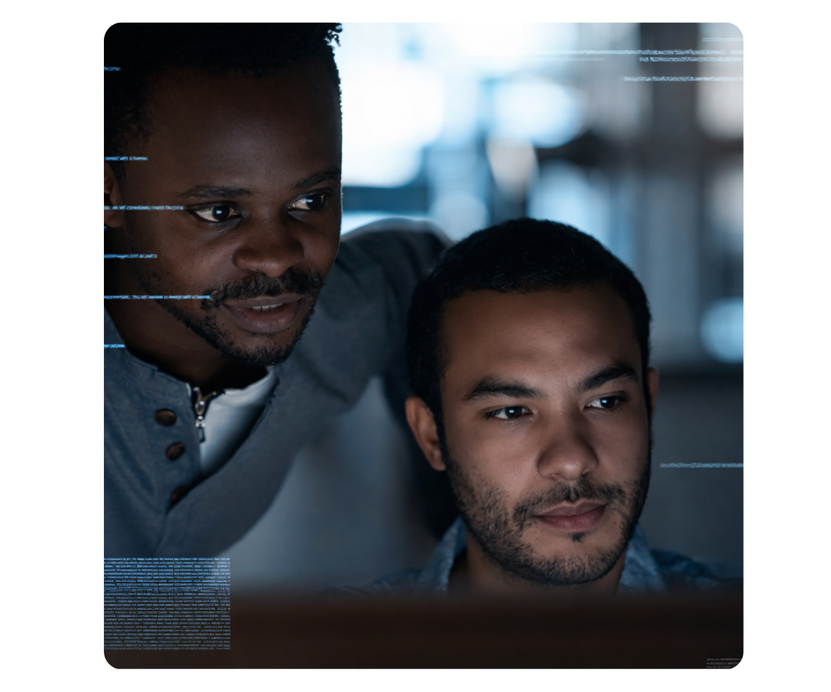 two men looking at a computer screen analyzing data