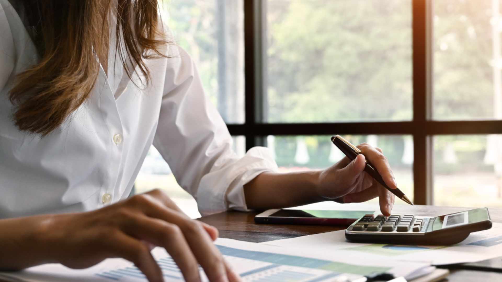 Featured image: woman calculating numbers on a calculator How AI is transforming credit risk faster than regulators can keep up