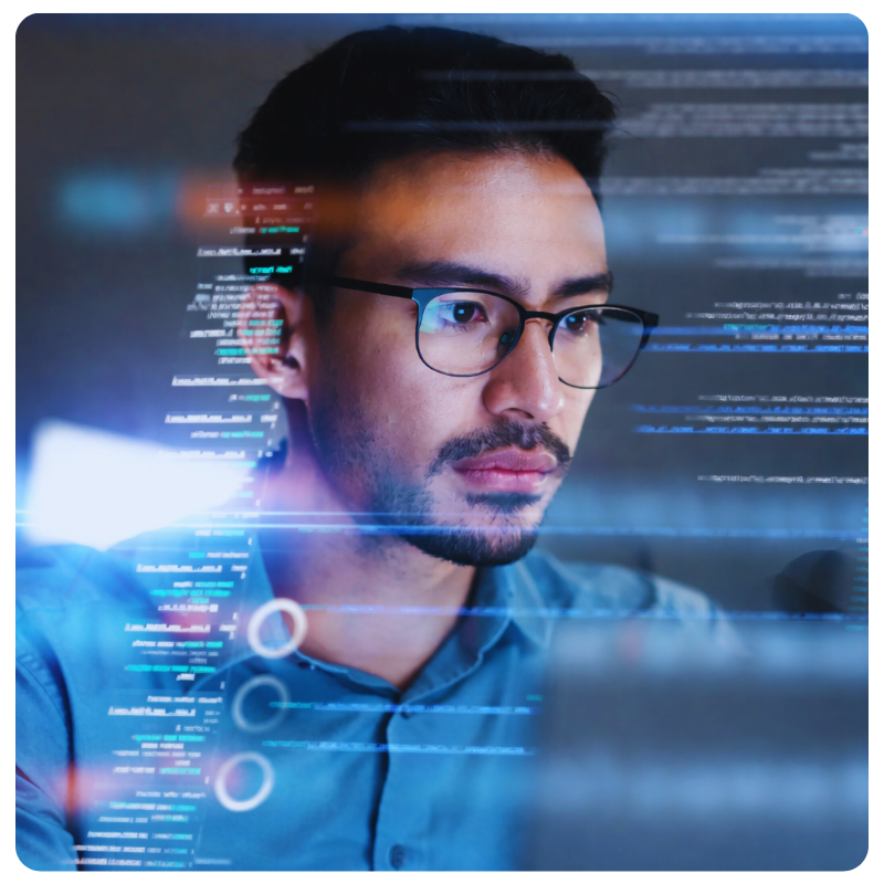 asian man in glasses analyzing data on a computer screen