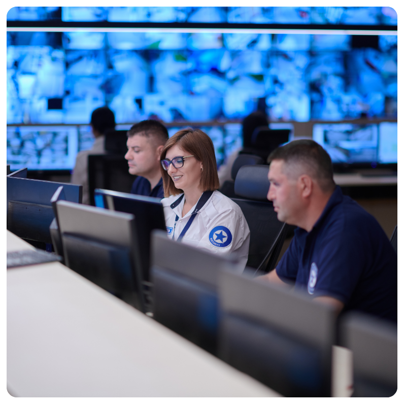 Security analysts monitoring systems in a security operations center to detect and respond to cyber threats.