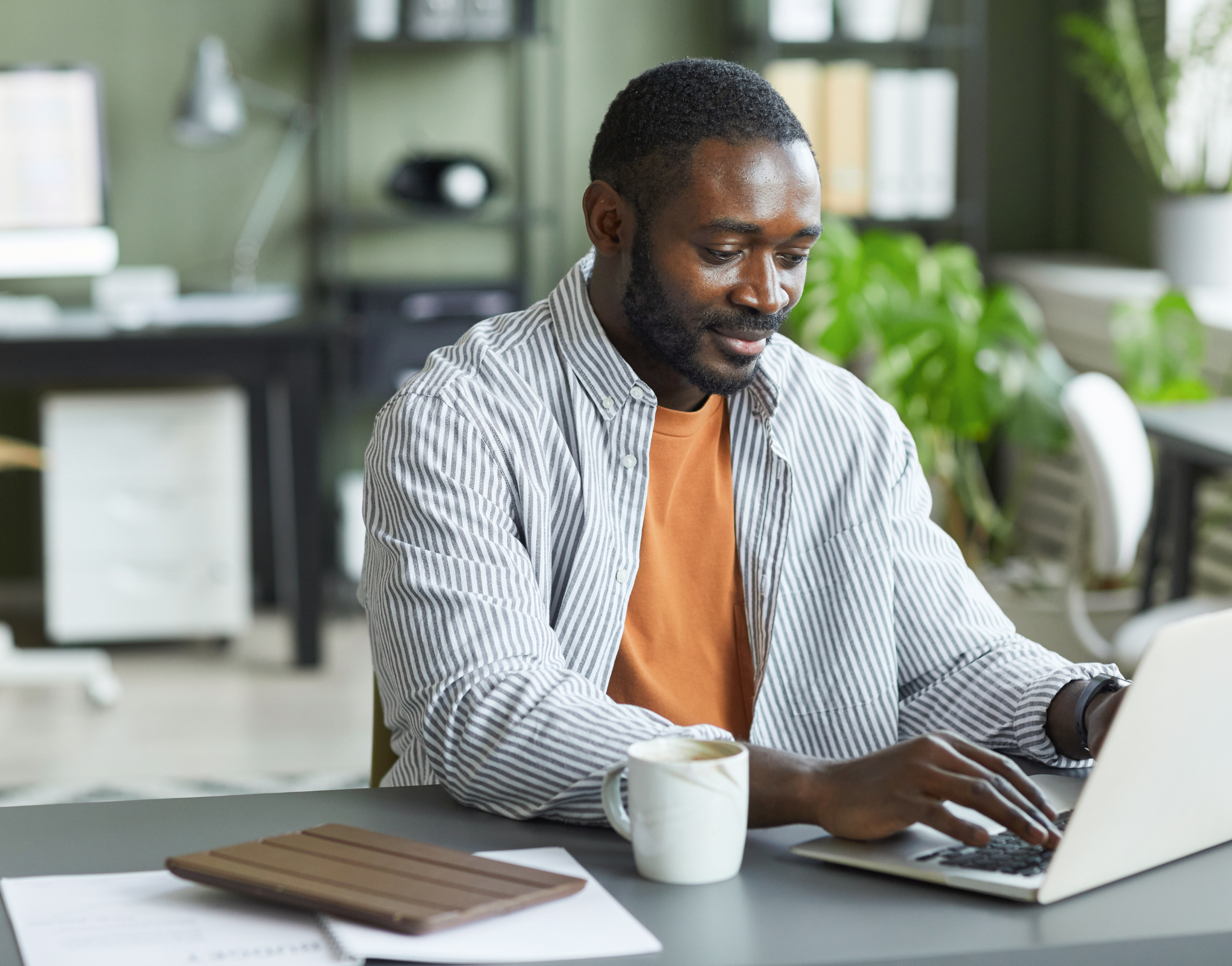 Featured image: black man on a laptopUsing GenAI to personalize customer journeys and forecast demand
