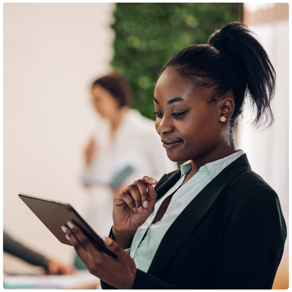 Technology professional reviewing operational data on a tablet.